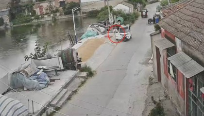 江苏徐州突降大雨，过路陌生大爷及时出手，给路面晒的小麦盖上雨布